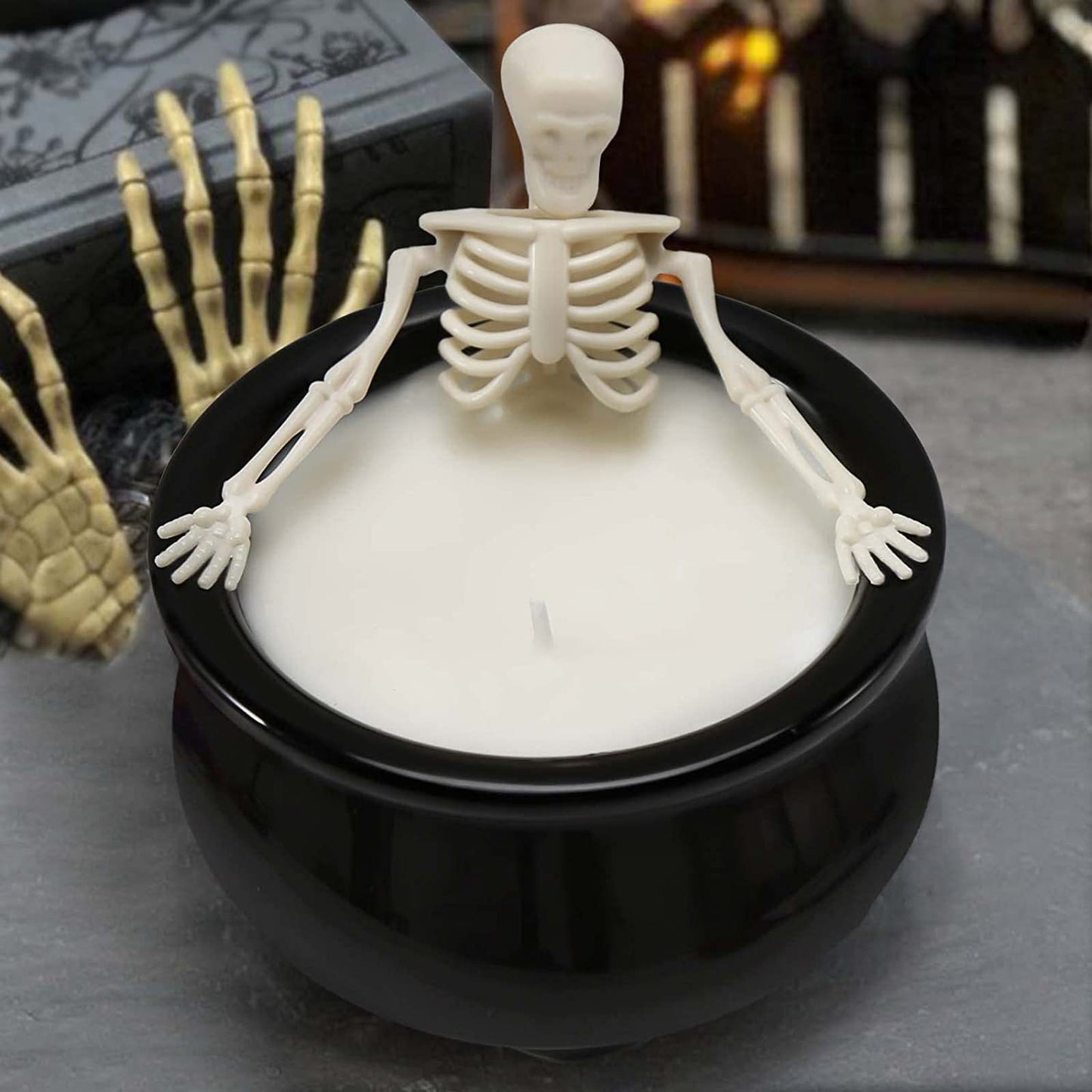 Skeleton in witch's cauldron candle