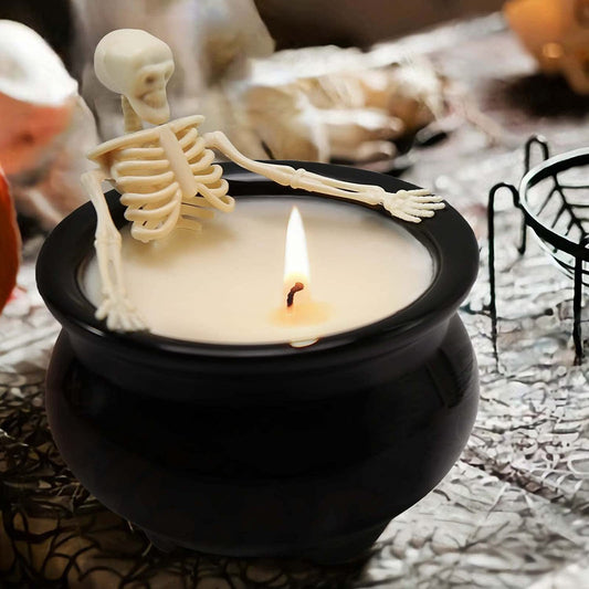 Skeleton in witch's cauldron candle