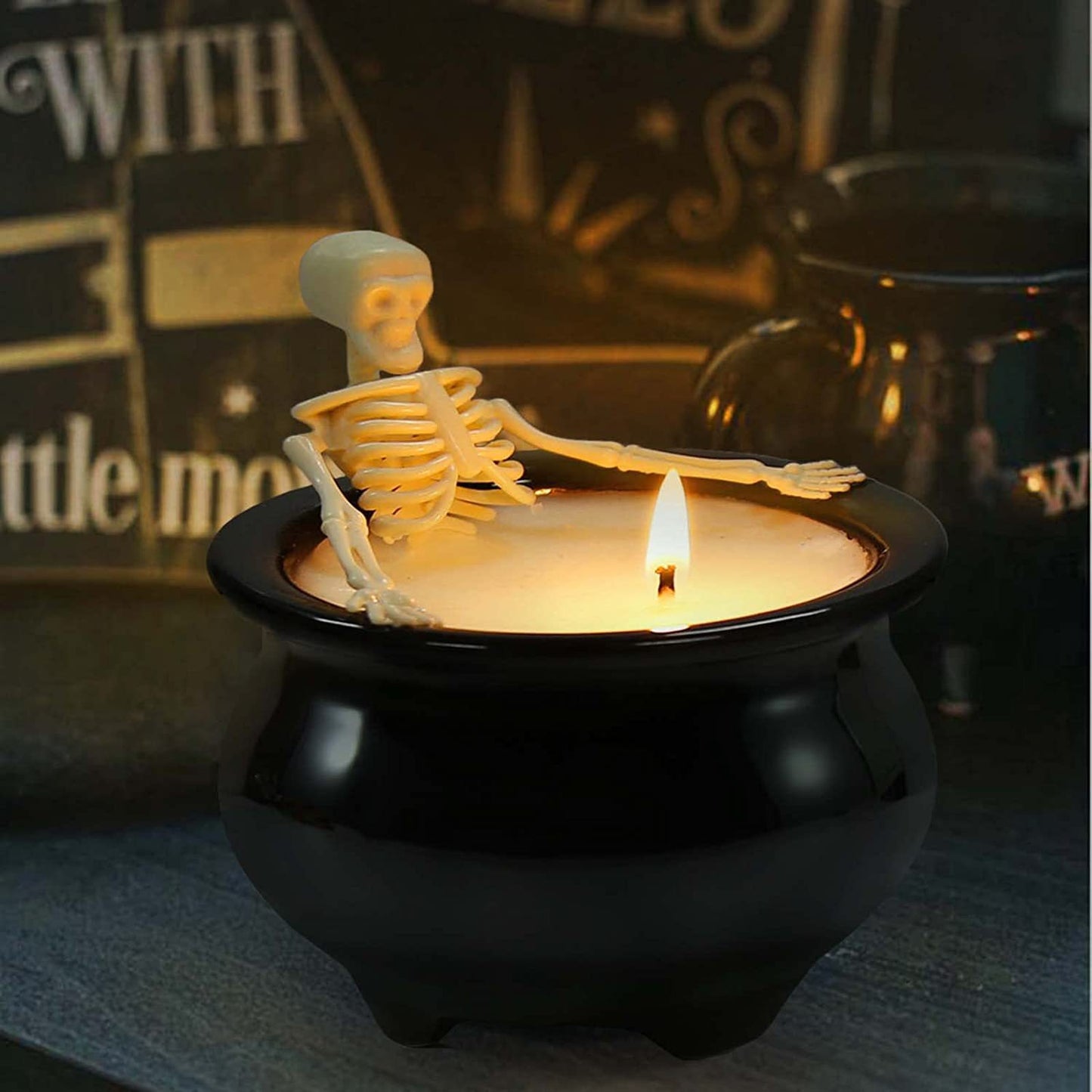 Skeleton in witch's cauldron candle